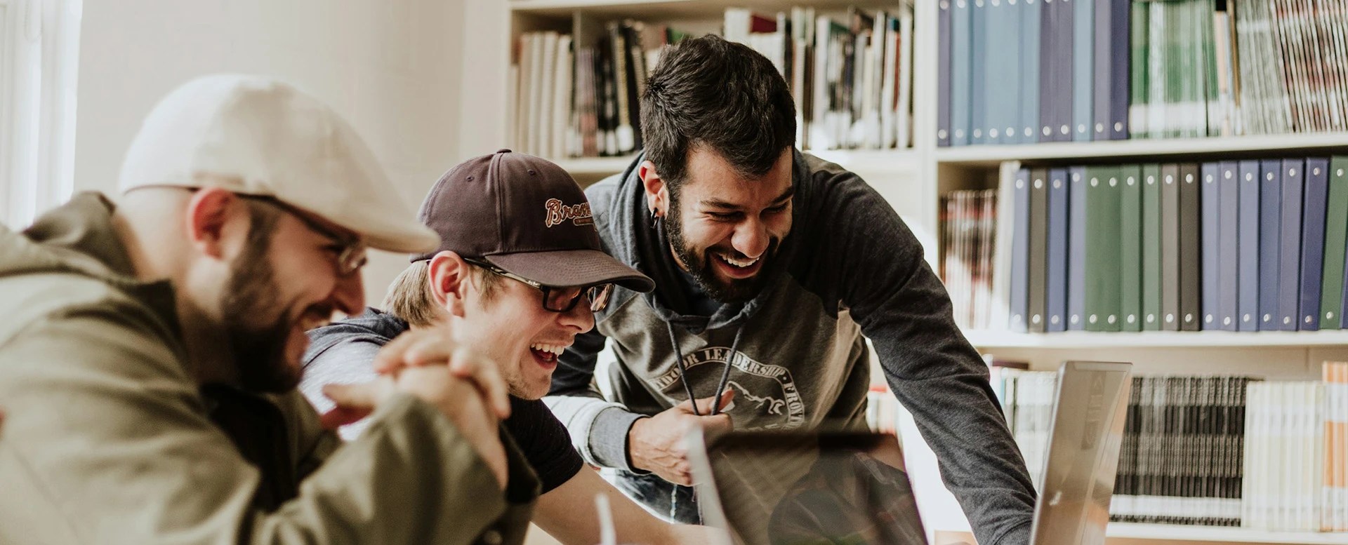 Team looking at a laptop together, laughing