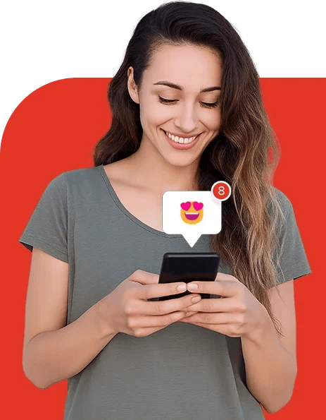 A smiling woman looking at her phone as a social media reaction notification appears